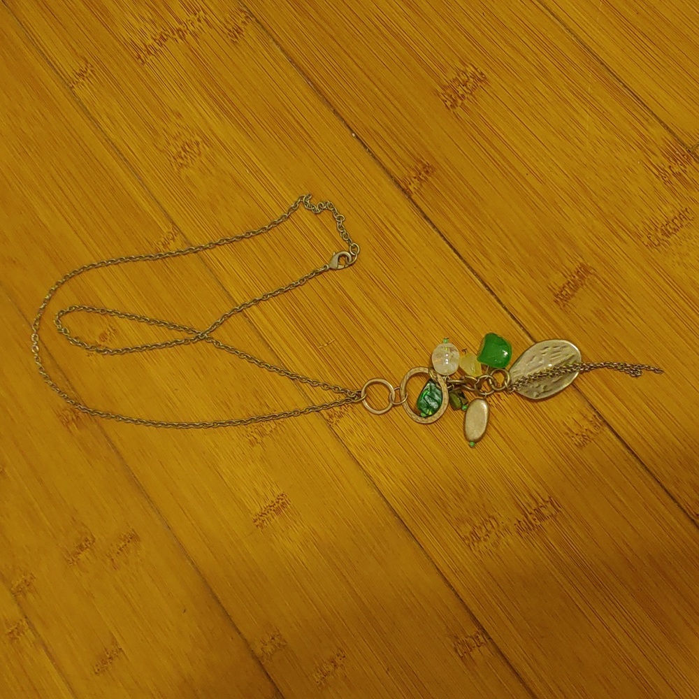 long chain necklace with green and gold charms